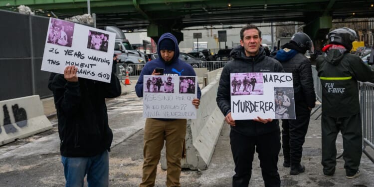 A few protestors hold signs in favor of Maduro's detention outside the MDC detention center on Jan. 5, 2026, in New York City.