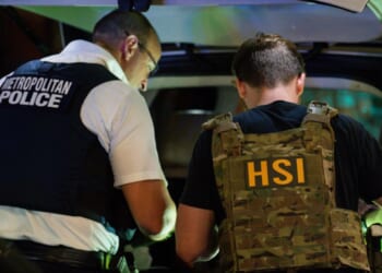 FBI, Metropolitan Police Department, Homeland Security Investigations, and Immigration and Customs Enforcement officers search the inside of a car during a traffic stop on Aug. 14, 2025, in Washington, D.C.