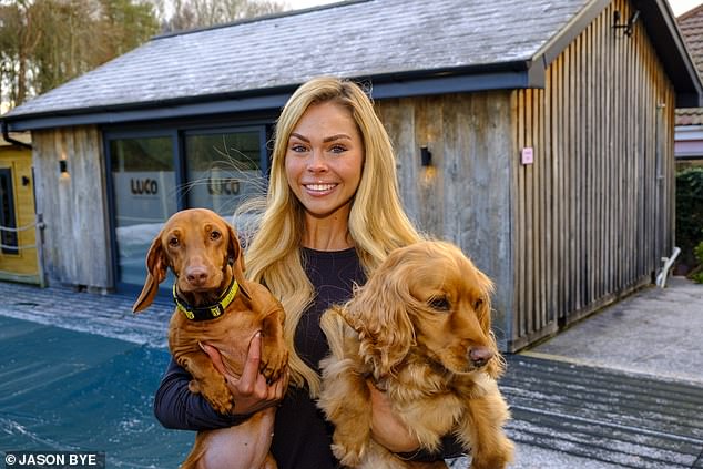 Megan pictured outside Luco Wellness which was named after her dachshund Lulu, who she brought back from Dubai, and her Cockapoo Coco