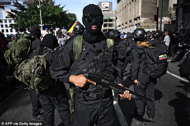 Armed supporters of Venezuela's President Nicolas Maduro gather near the Miraflores presidential palace in Caracas after his ouster