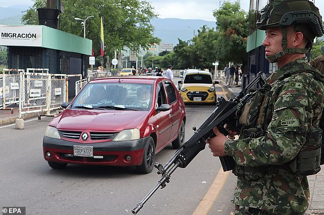 A member of the Colombian Army stands guard on the Simon Bolivar International Bridge connected to Venezuela