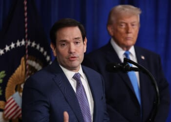 Secretary of State Marco Rubio speaks during a press conference as President Donald Trump listens at Mar-a-Lago club on Jan. 3, 2026, in Palm Beach, Florida.
