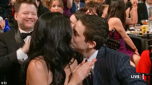The couple showed off their affection just after Timothee's name was announced with a sweet kiss as he rose to accept his award