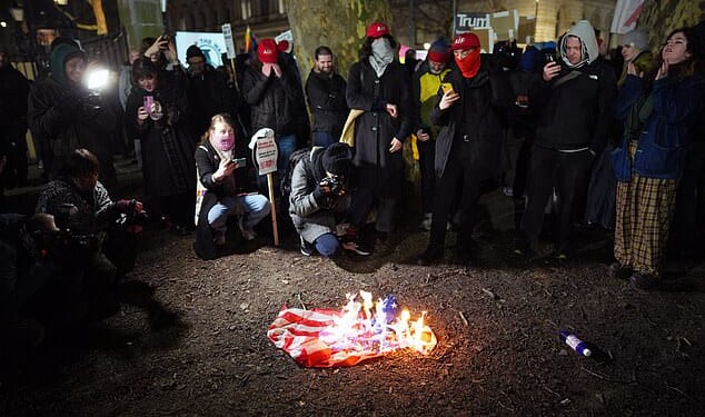 An American flag was set alight and stamped on outside Downing Streetas campaigners against Donald Trump's capture of Nicolas Madurochanted 'death, death to the USA'