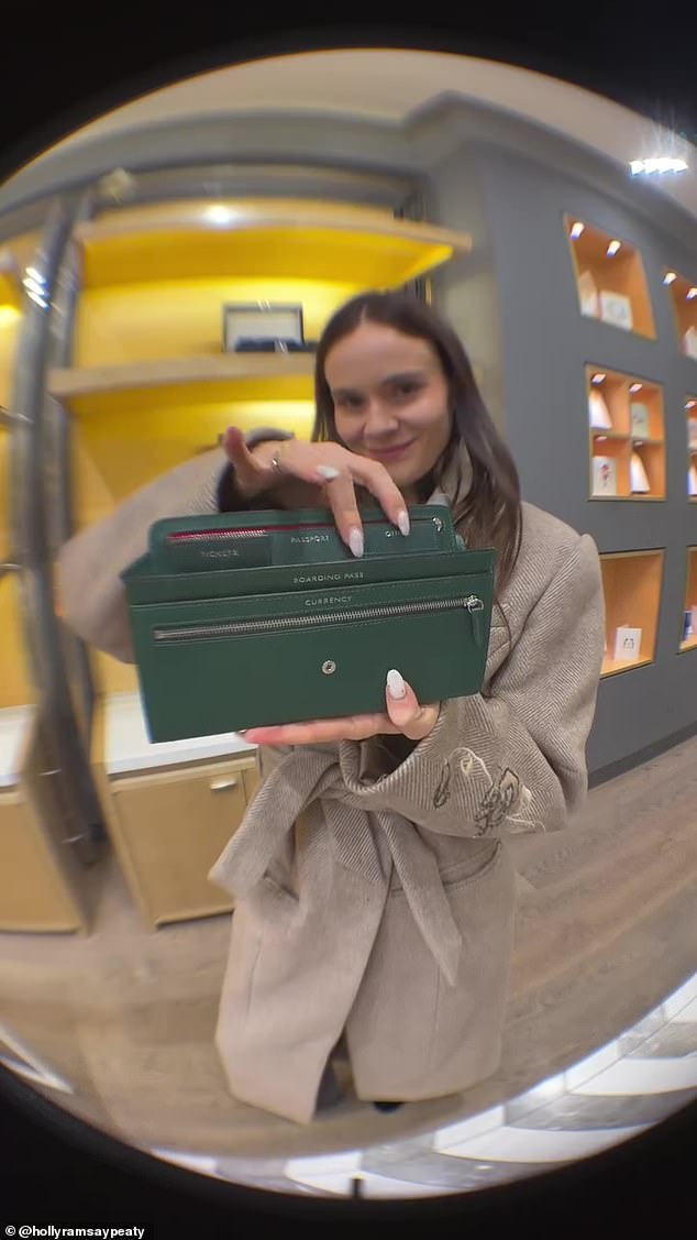 She showed off some of the personalised items she was given during the visit including this green wallet which matched the inside of her wedding invite envelopes