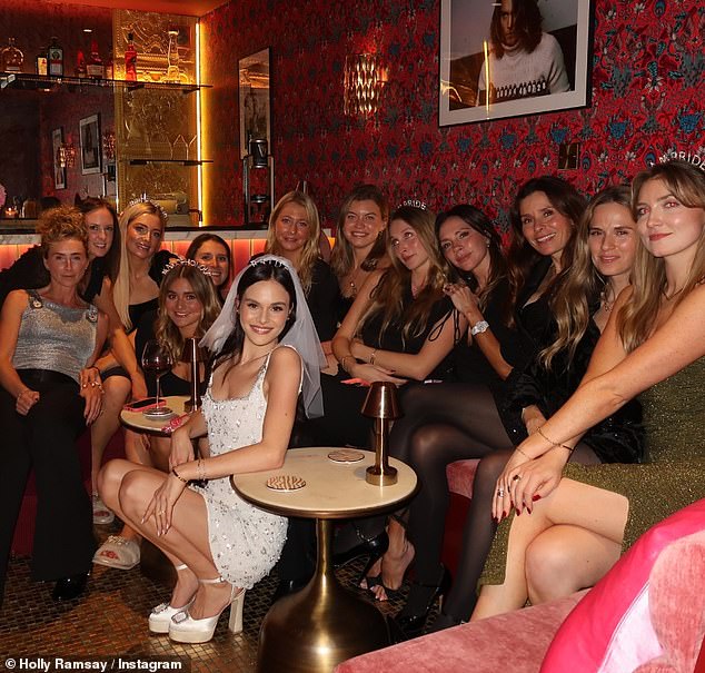 The astonishing family feud kicked off after news arose that Adam's mother was not invited to Holly's hen do, where she was joined by her mum Tana, Adam's sister Bethany and Victoria Beckham at Soho Farmhouse (Bethany pictured third from the left, behind Tilly Ramsay)