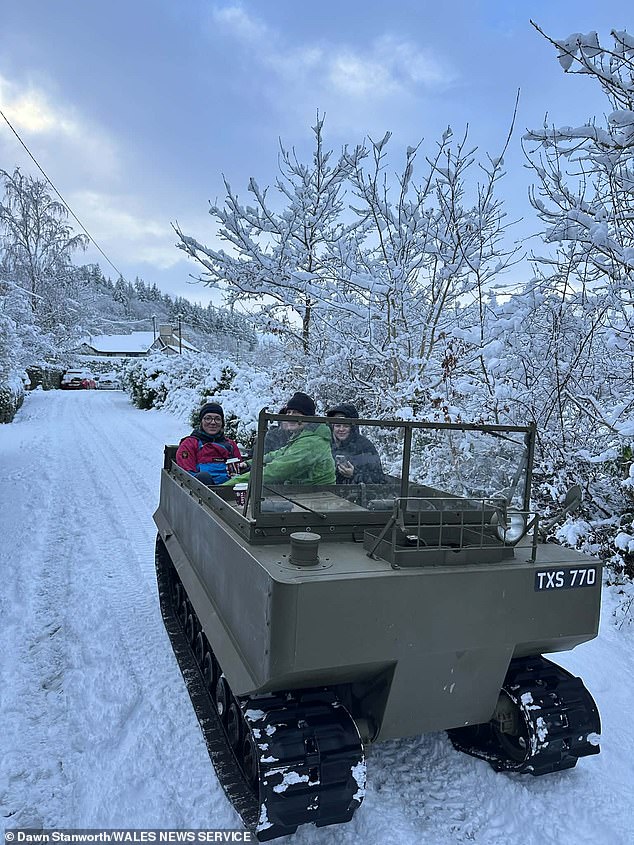 Several walkers who became stranded in heavy snow in Bethesda, Wales on Tuesday were rescued by a vintage WWII cargo carrier thanks to collector Andrew Singleton