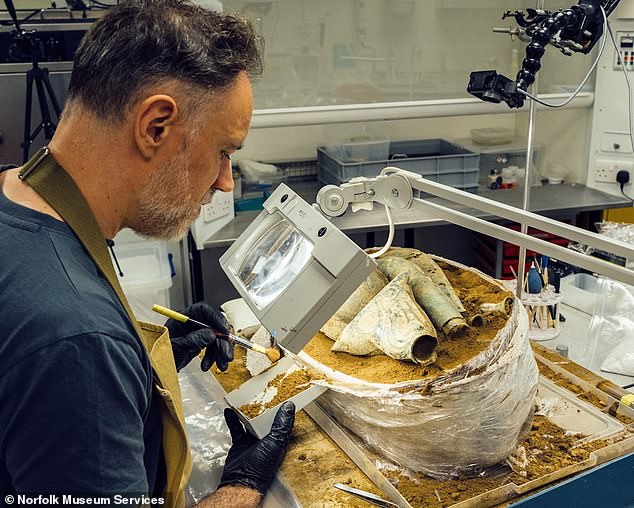 Senior conservator Jonathan Clark, undertaking the micro-excavation of the hoard. This delicate process involves carefully removing the objects from the block, securing and stabilizing the fragile material, documenting both the process and the finds and ensuring that no evidence is lost