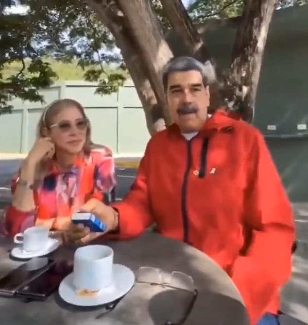 Upon realising he is being filmed, he surreptitiously hides the watch in his sleeve, and places his hand below the table