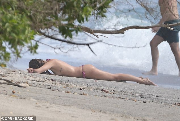 She laid down right by the shoreline to sunbathe