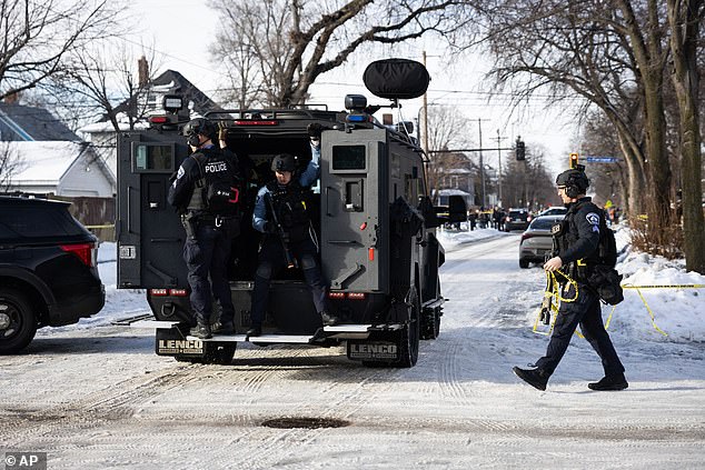 Pictured: Armed police officers arriving at the scene on Wednesday