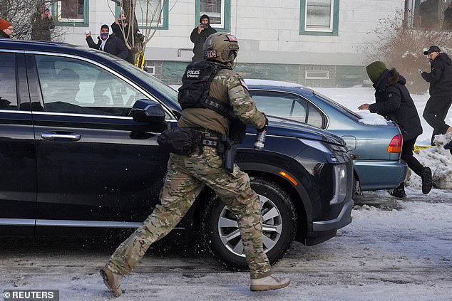 Pictured: A federal agent running toward residents