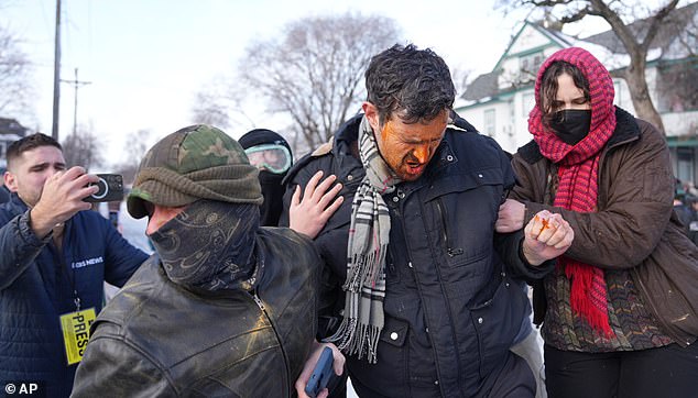 Protestors react after being hit with chemical spray at the scene of a shooting  in Minneapolis, on Wednesday, Jan. 7, 2026.  (Alex Kormann/Star Tribune via AP)