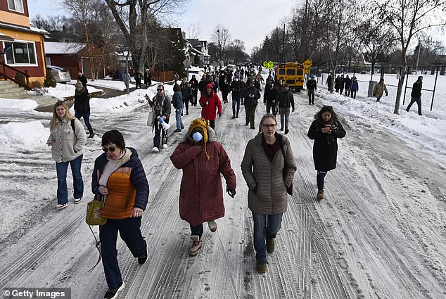 Demonstrators line the road near the scene of the shooting amid rising tensions in Minneapolis