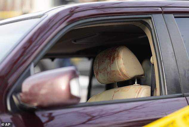 Blood is seen on the headrest of a vehicle at the scene of the shooting earlier today