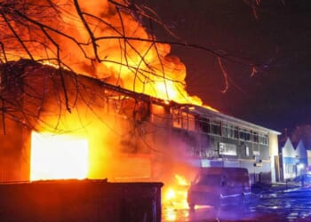 Two warehouses burn in huge blaze as 50 firefighters battle inferno engulfing buildings & setting off explosions