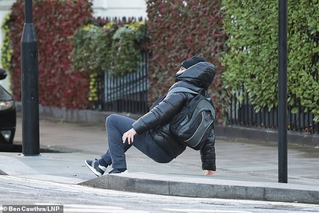 A commuter slips over on an icy pavement while walking through Little Venice in London on January 07, 2025