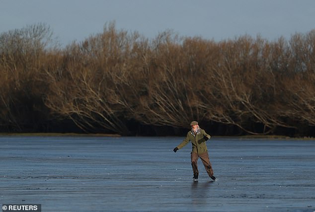 Robert Hazell, 77, of London, skates across a frozen flood plain at Port Meadow in Oxford