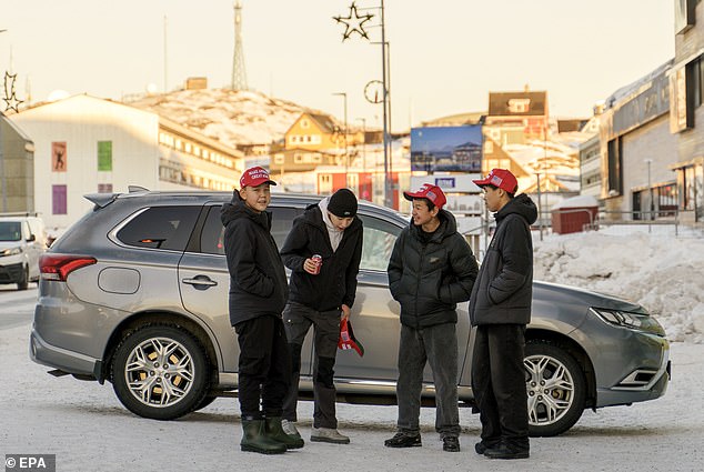 Young Greenlanders wearing MAGA hats stand near the Hotel Hans Egede during Donald Trump Jr.'s visit to Nuuk on January 07, 2025