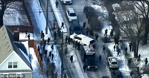 Protesters clash with police after a driver of a vehicle was shot on Wednesday amid an immigration enforcement surge in Minneapolis