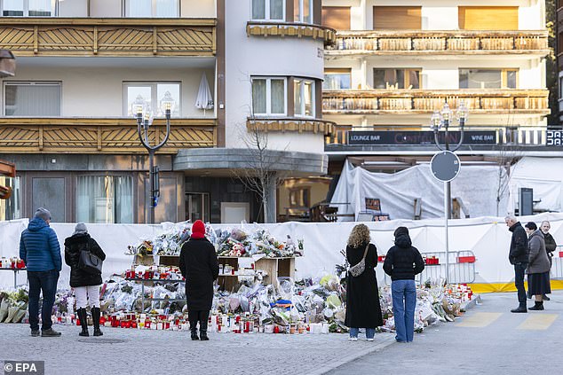 Flowers and candles are pictured on Monday in tribute to the victims of the fire at Le Constellation bar and lounge in Crans-Montana, Switzerland