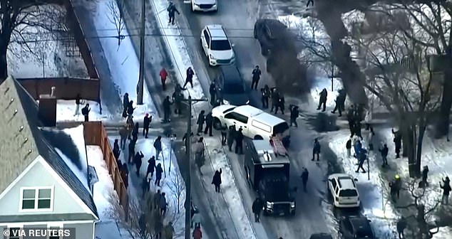 Protesters clash with police after a driver of a vehicle was shot on Wednesday amid an immigration enforcement surge in Minneapolis