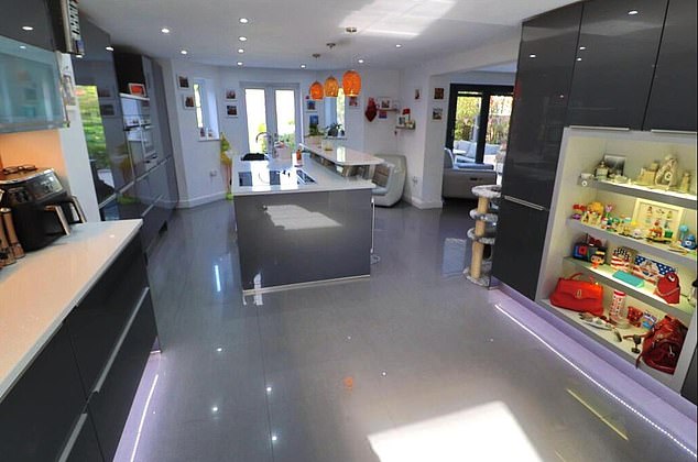 Estate agents hailed the 'spacious' property as offering 'excellent accommodation in a highly sought after location', noting its underfloor heating, log-burning stove, bi-fold doors, wine coolers and high-spec kitchen