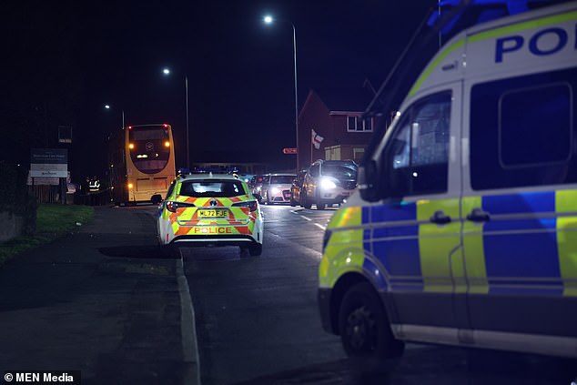 Police and forensic officers attend the scene involving a bus and three school children