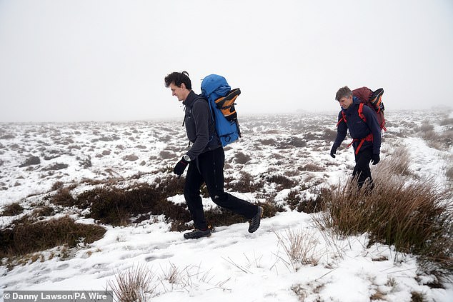 Ice climbers head out from Featherbed Moss in the Peak District this morning