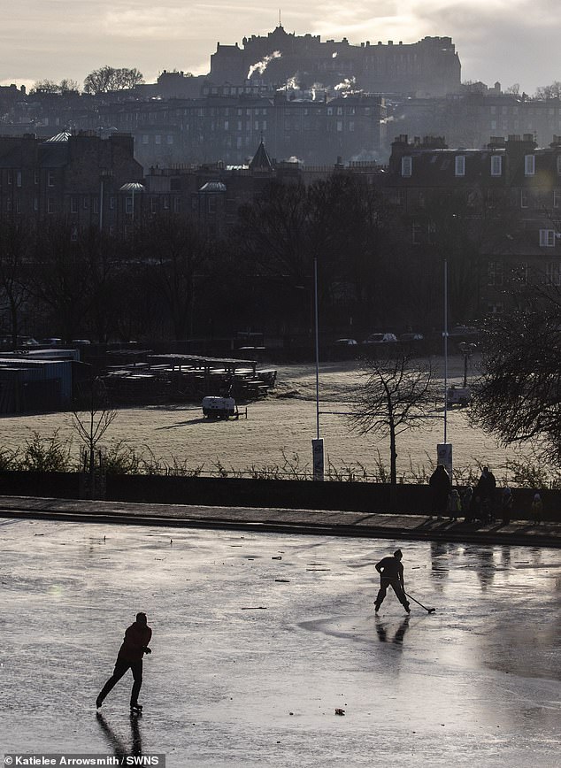 Ice skaters make the most of the cold on a frozen pond at Inverleith Park in Edinburgh today