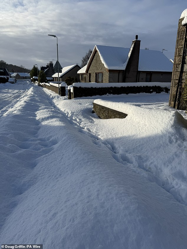 Insch in Aberdeenshire, pictured yesterday, has seen 30cm (1ft) of snow in recent days