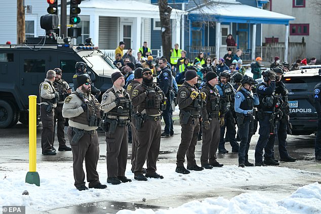 Law enforcement stands guard after the shooting