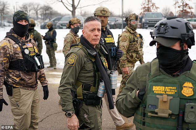 Border Patrol Commander Gregory Bovino walks with federal agents outside the Bishop Henry Whipple Federal Building a day after she was shot and killed