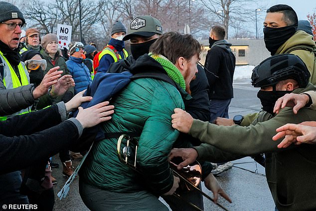 A federal agent detains a demonstrator, at a protest against the fatal shooting of Renee Nicole Good by a U.S. Immigration and Customs Enforcement (ICE) agent