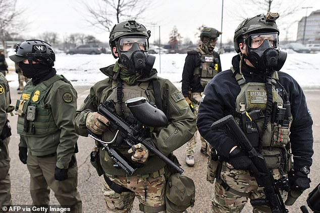 Federal agents stand guard as protestors gather outside the Bishop Henry Whipple Federal Building in Saint Paul, Minnesota, on January 8, 2026