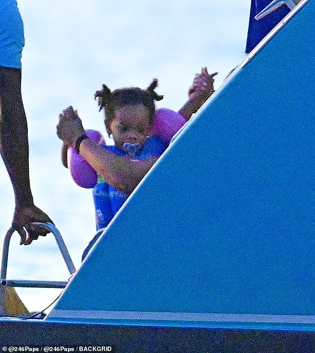 Her eldest son, RZA, pictured wearing arm floaties and a blue life vest