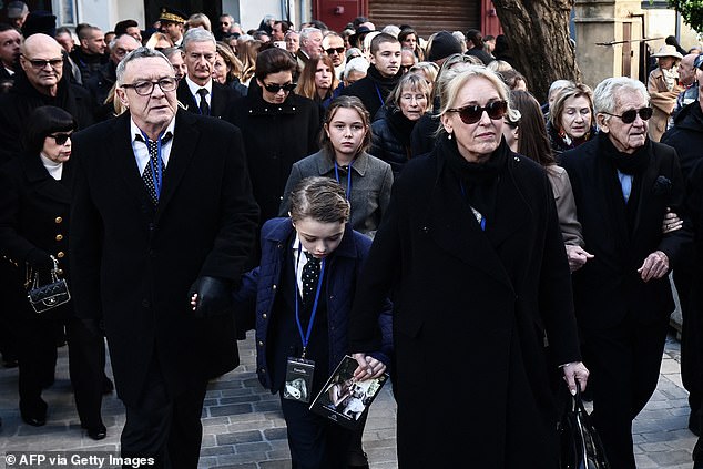 Brigitte Bardot's son Nicolas-Jacques Charrier (L) walks in the cortege behind the hearse transporting the coffin of his mother