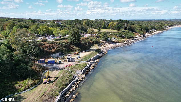 Workers pictured at the beach removing the sea defences to allow nature to 'take its course'