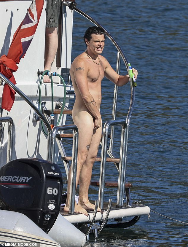 Yungblud swigged from a bottle as he descended the stairs for a skinny dip