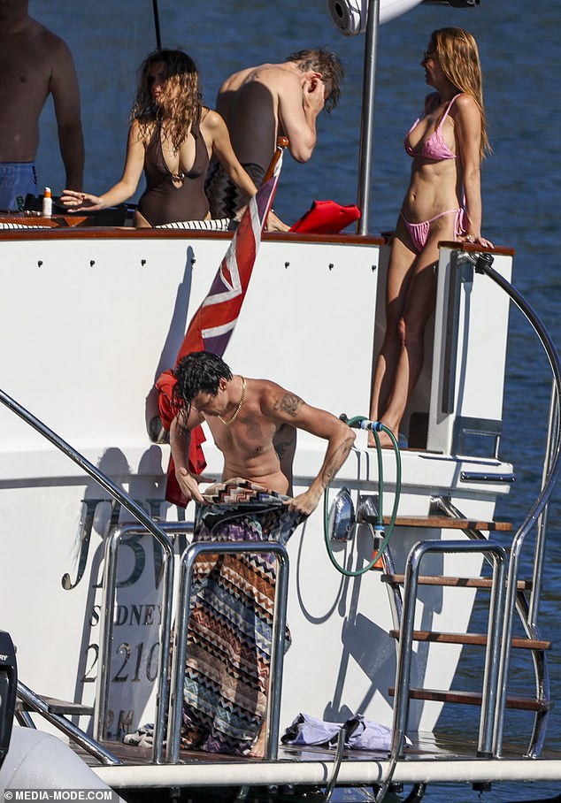 Other guests included a woman dressed in a brown one-piece swimsuit