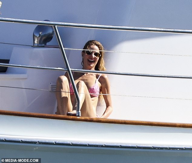 Dina looked like she was having the time of her life as she sat on the sun-drenched deck