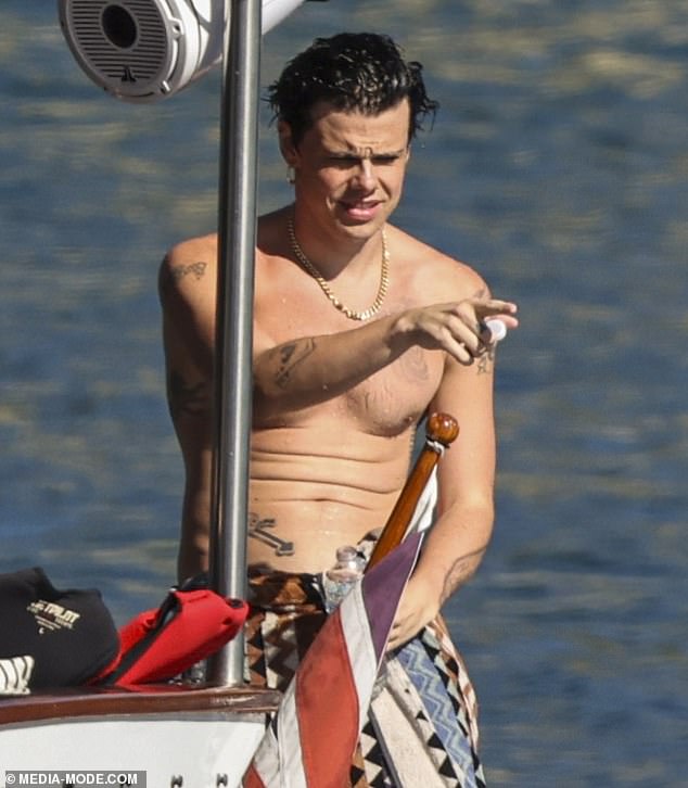 Sharing a pouty photo of himself in the back of a car, he wrote: 'Australia I'm here. Tell the cougars I'll see em Saturday night'