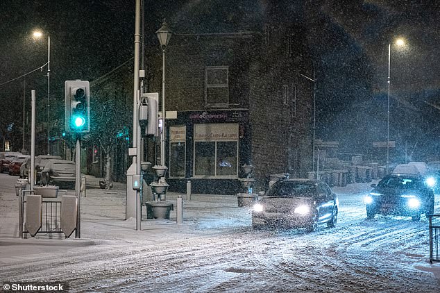 Vehicles struggle at a road junction in the town of Mossley in Tameside, Greater Manchester
