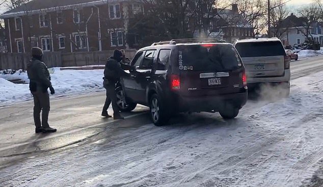 After about three minutes, an ICE agent walked around Ms Good's vehicle, whose back window was festooned with stickers, filming on his phone. 'Get out of the car! Get out of the f*****g car!' shouted one of them as a balaclava-clad agent grabbed the door handle on the driver's side and reached through the open window