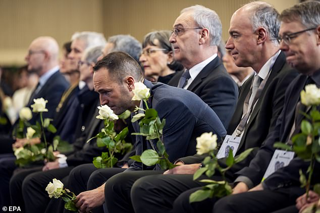 Mathias Reynard (L), State Councillor and president of the Council of State of the Canton of Valais, reacts next to Swiss Federal President Guy Parmelin (C) and his wife Caroline Parmelin, Christophe Darbellay (2-R)