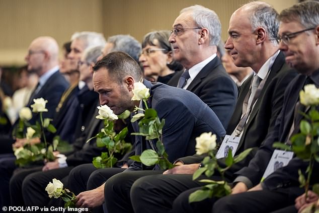 Switzerland's President Guy Parmelin (3rd R), State Councillor and president of the Council of State of the Canton of Valais Mathias Reynard (L) and State Councillor and Vice-President of the Council of State of the Canton of Valais Christophe Darbellay (2nd R) attend a tribute ceremony for the victims of the deadly fire