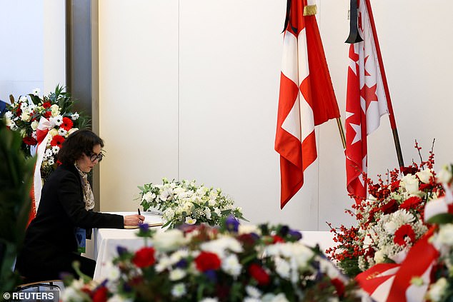 EU Commissioner Hadja Lahbib writes a message on the day of a national mourning ceremony for the victims of the deadly fire at Le Constellation bar during a New Year's Eve party in Crans-Montana, in Martigny, Switzerland, January 9, 2026