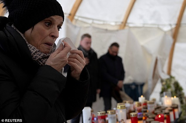 People visit a makeshift memorial outside the Le Constellation bar, following a deadly fire during a New Year's Eve party, in the upscale ski resort of Crans-Montana in southwestern Switzerland, January 9, 2026