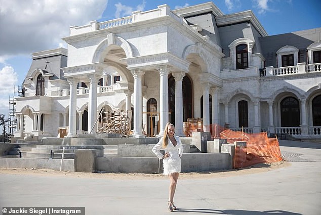 Jackie 'Queen of Versailles' Siegel standing outside a massive section of the palatial estate