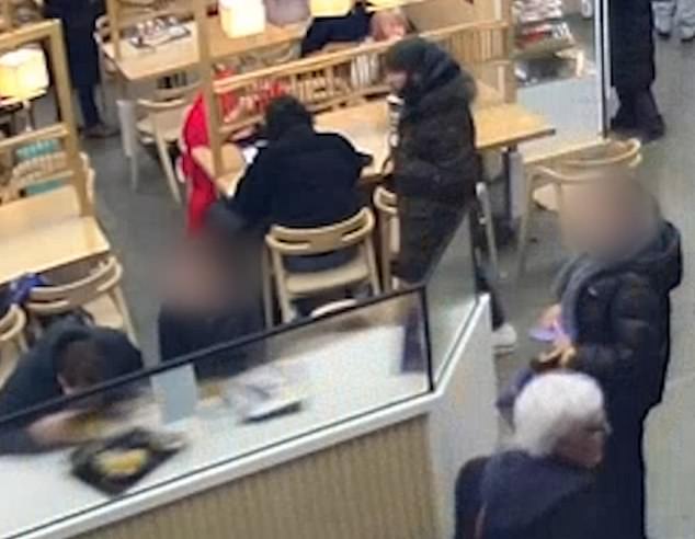 CCTV footage has now emerged of the thief, pictured standing up, centre, entering Kineya Mugimaru restaurant in the station before standing behind a man and woman having dinner